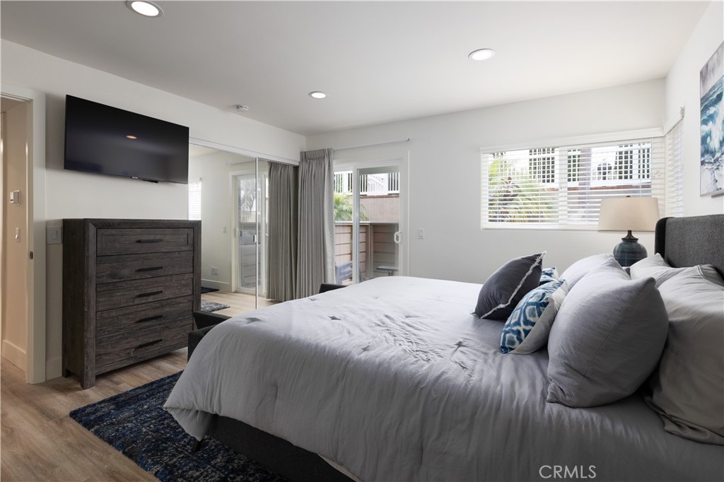 34116 Selva Road, Unit 308 Dana Point, CA 92629 - Photo 18 of 29 a bedroom with a bed and a flat screen tv