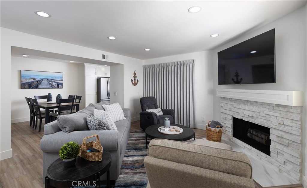 34116 Selva Road, Unit 308 Dana Point, CA 92629 - Photo 7 of 29 a living room with furniture and a fireplace