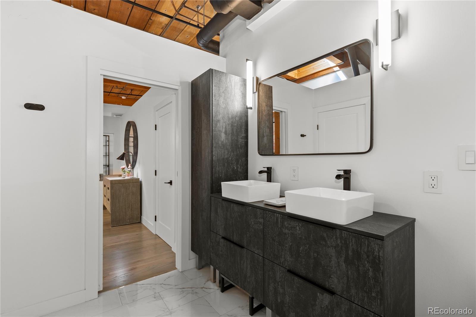 1616 14th Street, Unit 5B Denver, CO 80202 - Photo 14 of 26 a bathroom with a sink vanity and mirror