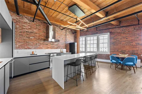a kitchen with stainless steel appliances granite countertop sink stove top oven and cabinets