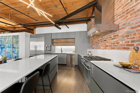 a kitchen with a stove a sink and cabinets