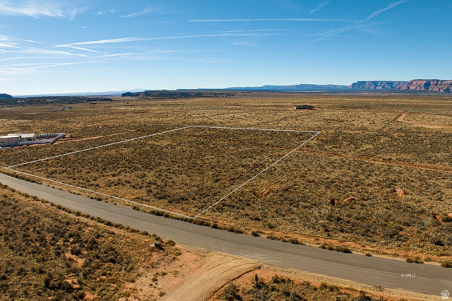 11 Crimson Road East, Unit 11 Kanab, UT 84741 - Photo 11 of 21 Aerial view of sparsely populated area featuring mountains and a desert landscape