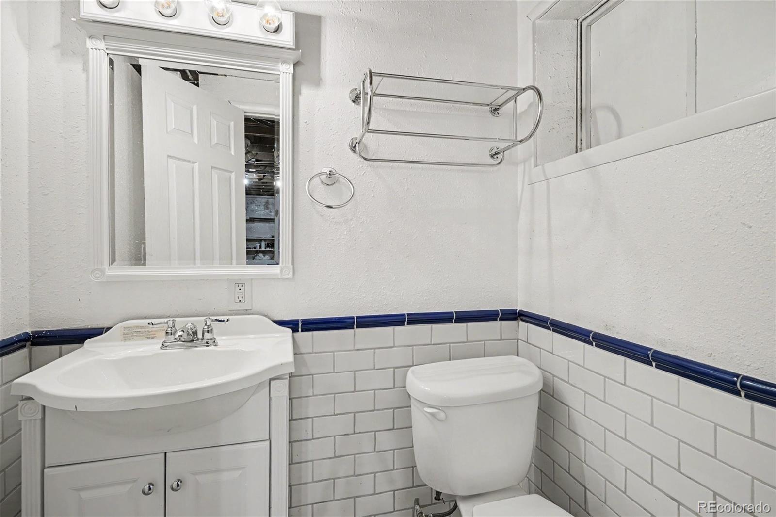 3217 South Stuart Street Denver, CO 80236 - Photo 21 of 29 a bathroom with a sink a toilet and shower
