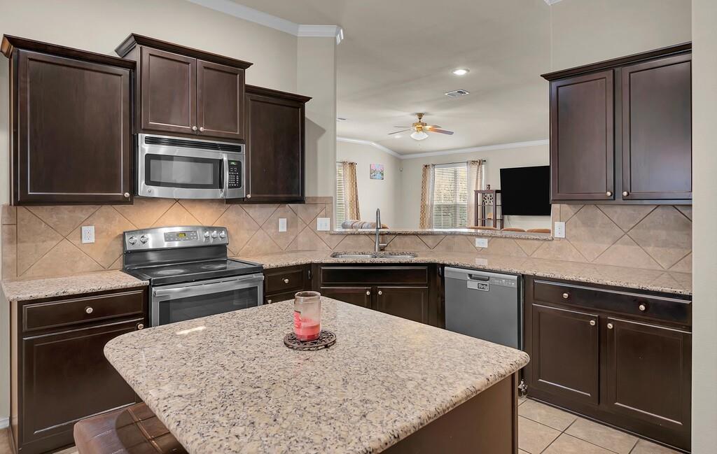 9801 Shallow Creek Drive Waco, TX 76708 - Photo 13 of 31 a kitchen with a sink stove and microwave