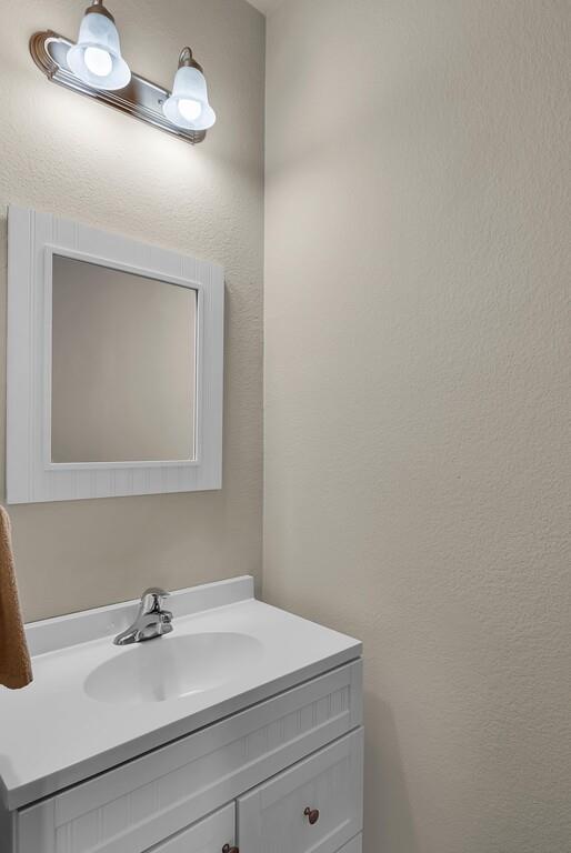 9801 Shallow Creek Drive Waco, TX 76708 - Photo 17 of 31 a bathroom with a sink a mirror and vanity