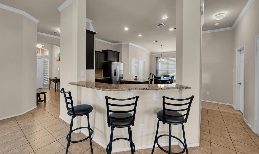 9801 Shallow Creek Drive Waco, TX 76708 - Photo 10 of 31 a kitchen with a dining table chairs and view living room