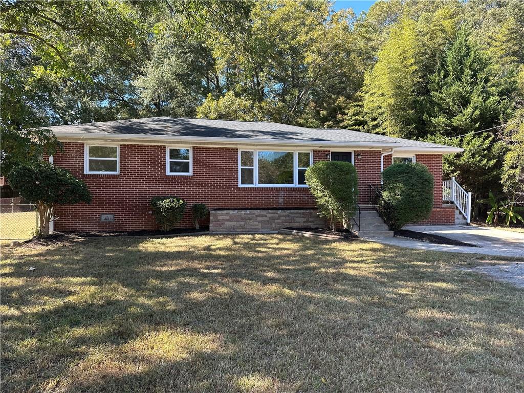 2078 Olive Springs Road Southeast Marietta, GA 30060 - Photo 1 of 1 a front view of a house with garden