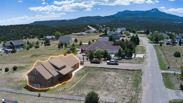 an aerial view of a house with a garden