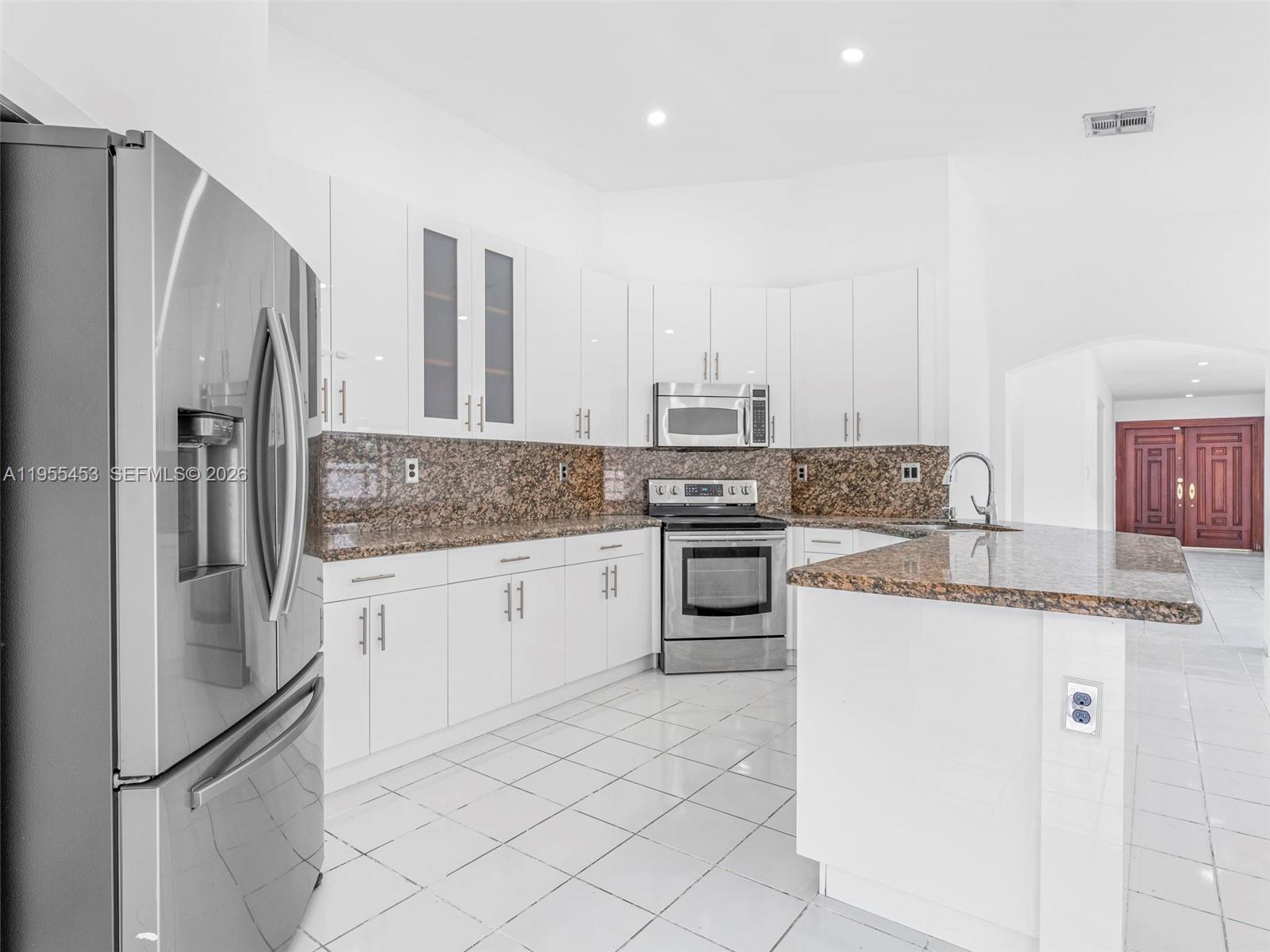 9435 Southwest 156th Place Miami, FL 33196 - Photo 12 of 45 a kitchen with a refrigerator sink and stove