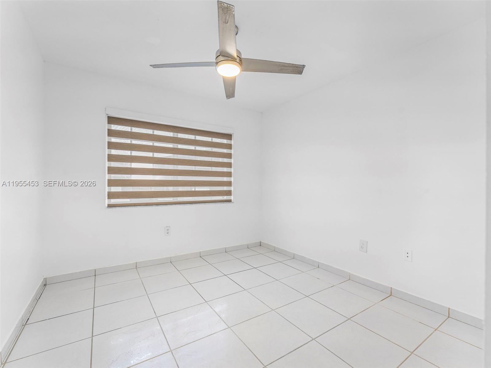 9435 Southwest 156th Place Miami, FL 33196 - Photo 27 of 45 a view of an empty room with a window