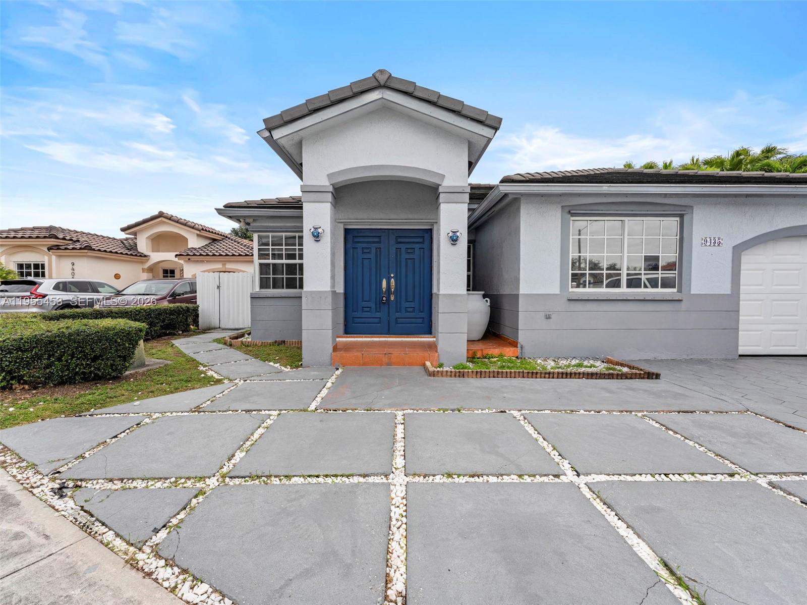 9435 Southwest 156th Place Miami, FL 33196 - Photo 37 of 45 a front view of a house with a yard and garage