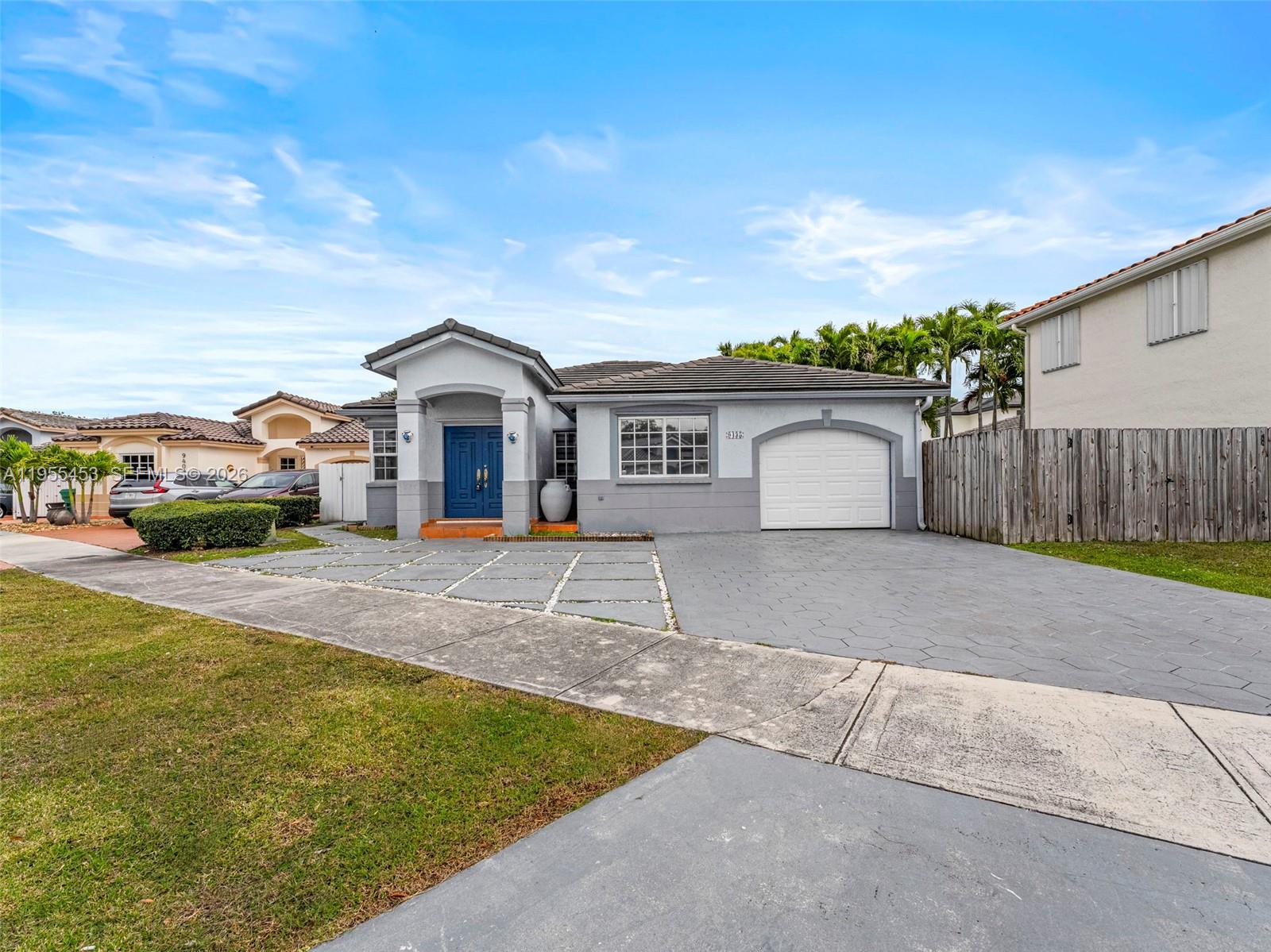 9435 Southwest 156th Place Miami, FL 33196 - Photo 38 of 45 a front view of a house with a yard and garage