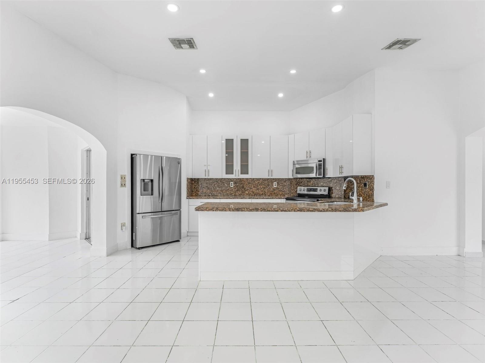 9435 Southwest 156th Place Miami, FL 33196 - Photo 8 of 45 a view of kitchen with granite countertop cabinets and refrigerator