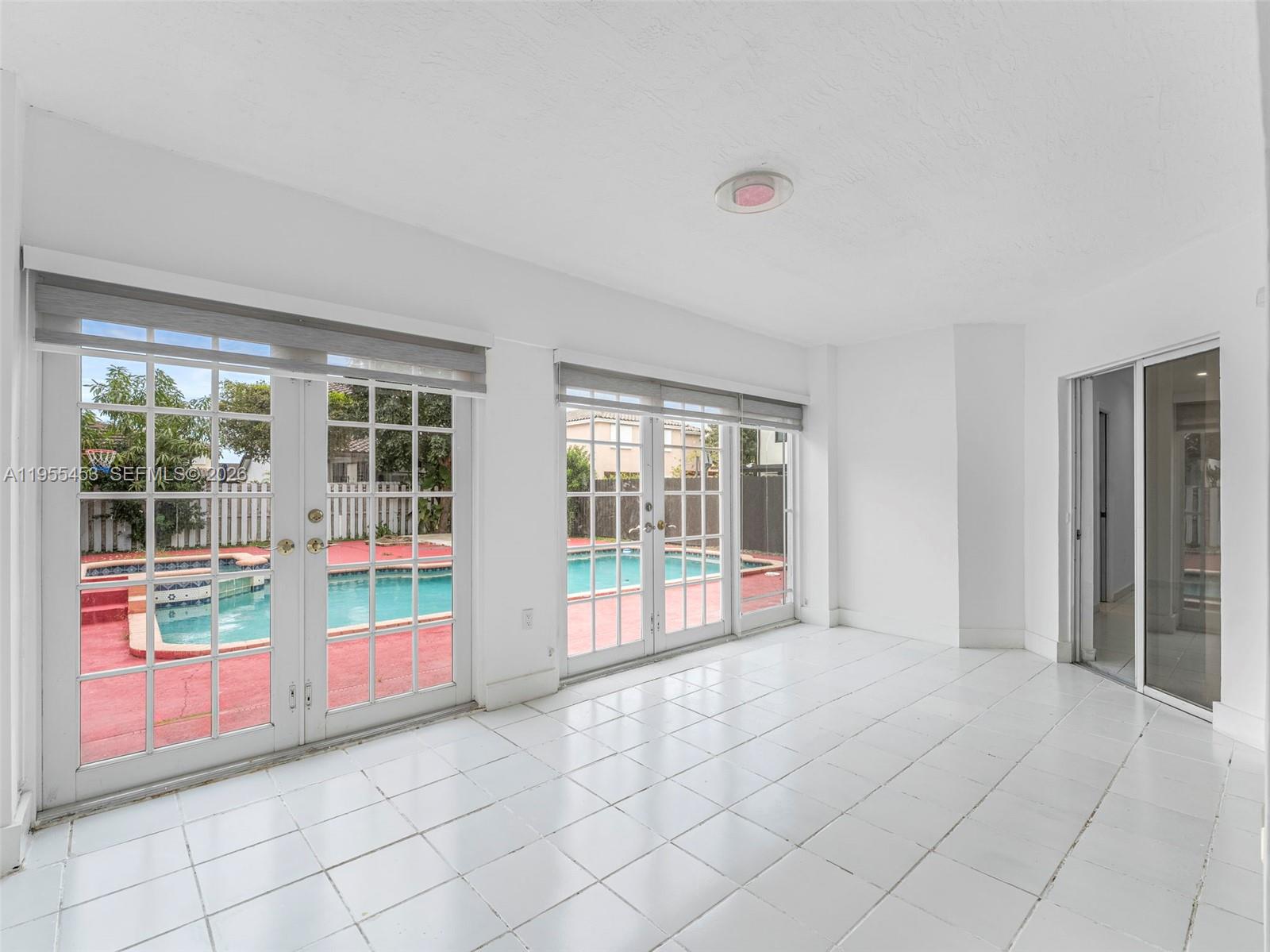 9435 Southwest 156th Place Miami, FL 33196 - Photo 9 of 45 a view of an empty room with glass windows