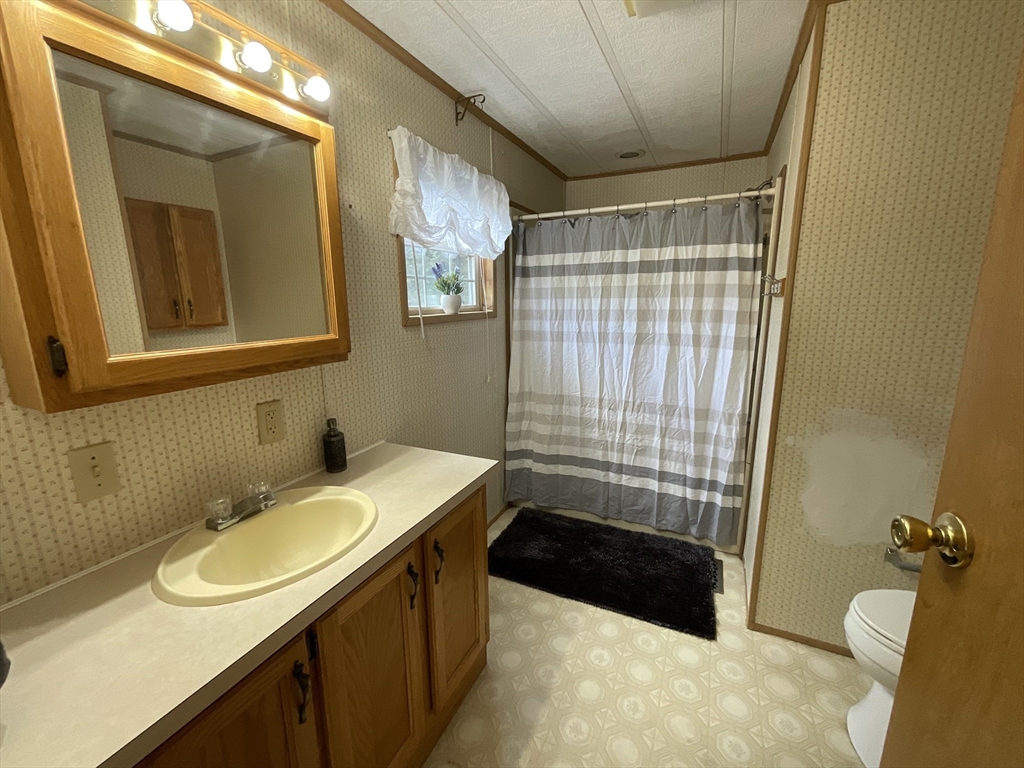 16 Agent Road Raymond, NH 03077 - Photo 12 of 35 a bathroom with a sink toilet and shower