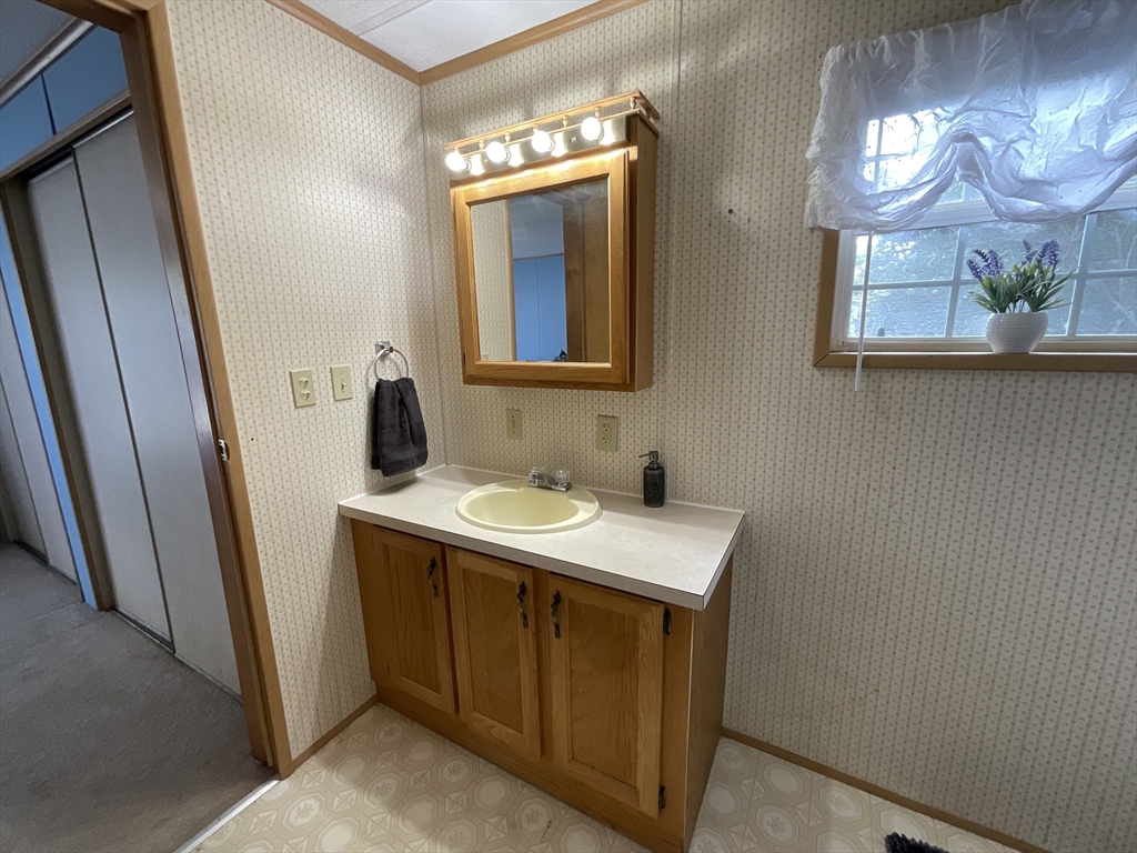 16 Agent Road Raymond, NH 03077 - Photo 16 of 35 a bathroom with a sink and a mirror