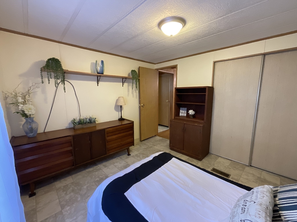 16 Agent Road Raymond, NH 03077 - Photo 20 of 35 a bedroom with a bed and a mirror