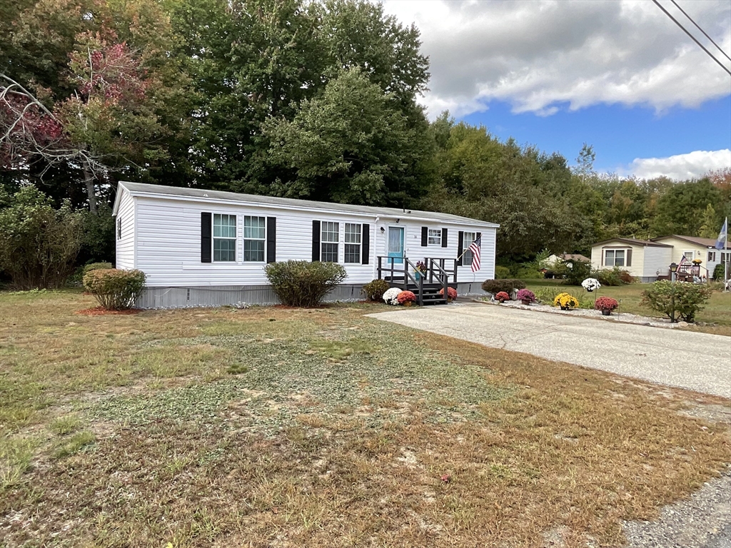 16 Agent Road Raymond, NH 03077 - Photo 2 of 35 a view of a house with backyard and sitting area