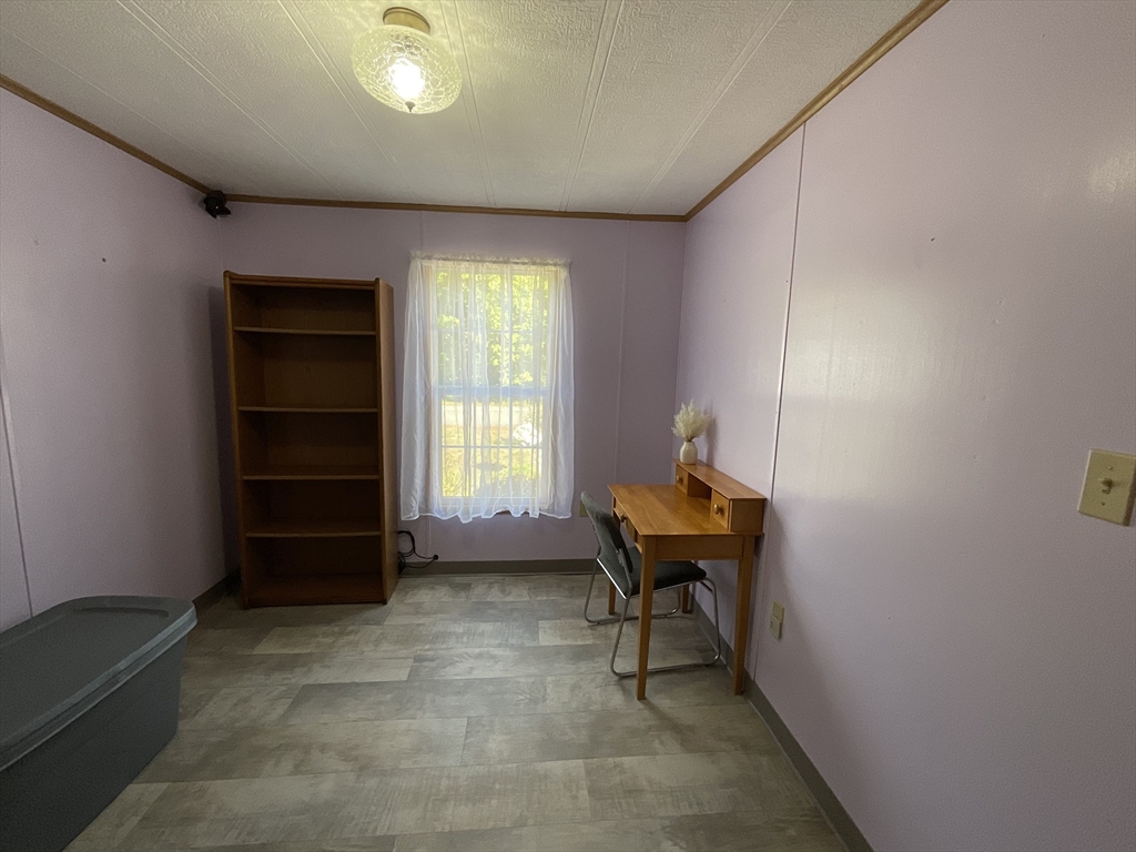 16 Agent Road Raymond, NH 03077 - Photo 23 of 35 a room with a chair and a window