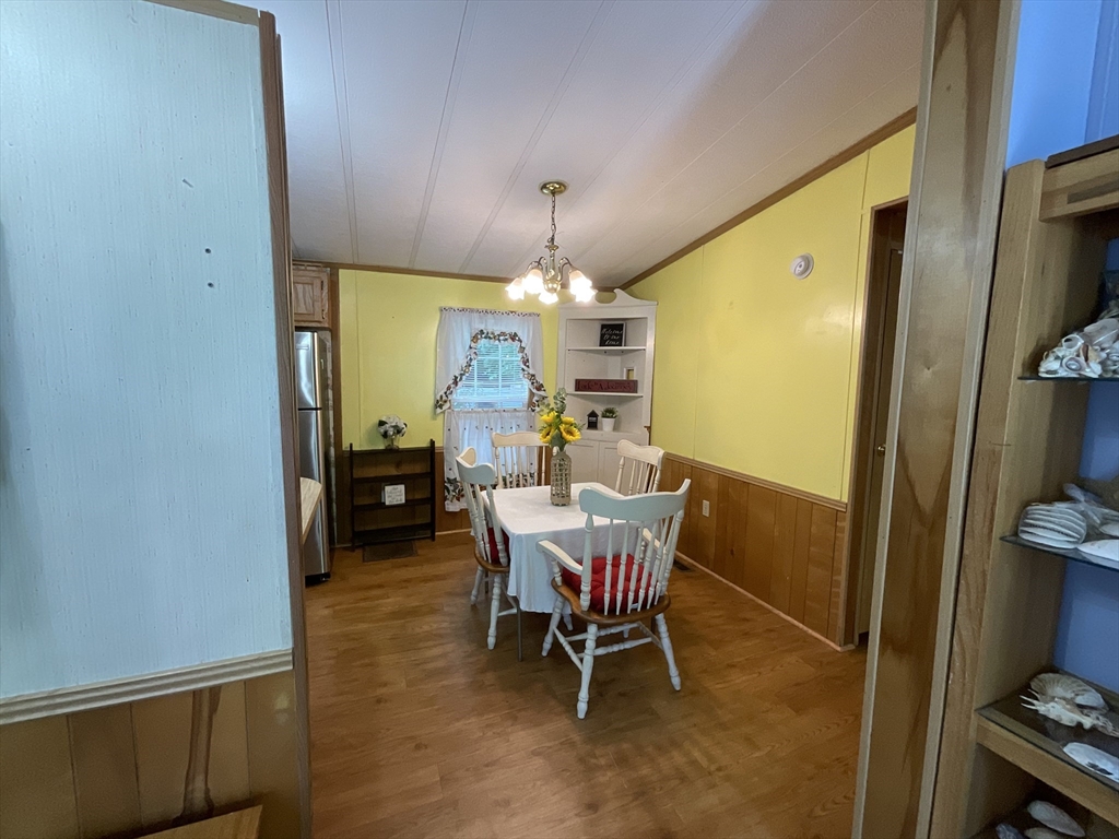16 Agent Road Raymond, NH 03077 - Photo 27 of 35 a view of a dining room with furniture and chandelier