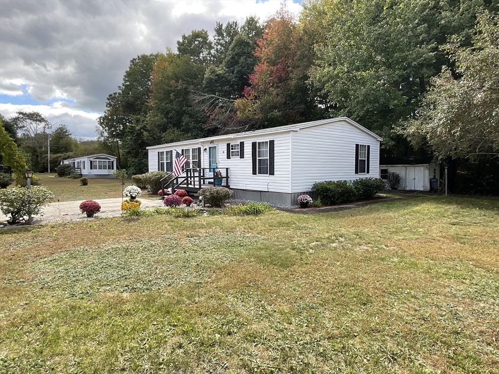 16 Agent Road Raymond, NH 03077 - Photo 3 of 35 a backyard of a house with table and chairs