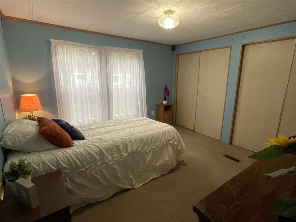 16 Agent Road Raymond, NH 03077 - Photo 33 of 35 a bedroom with a bed and a window