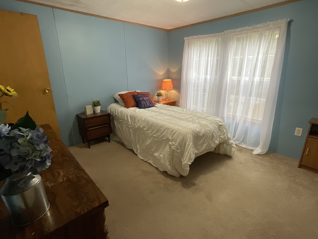 16 Agent Road Raymond, NH 03077 - Photo 34 of 35 a bed sitting in a spacious bedroom next to a window