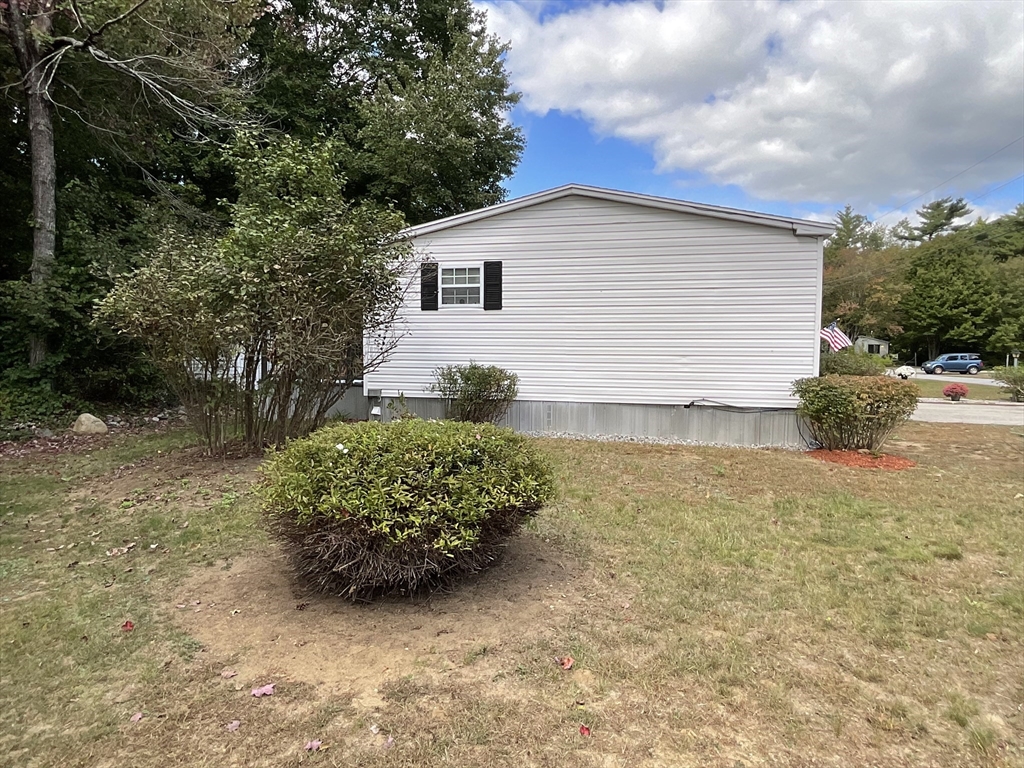 16 Agent Road Raymond, NH 03077 - Photo 8 of 35 a backyard of a house with lots of green space