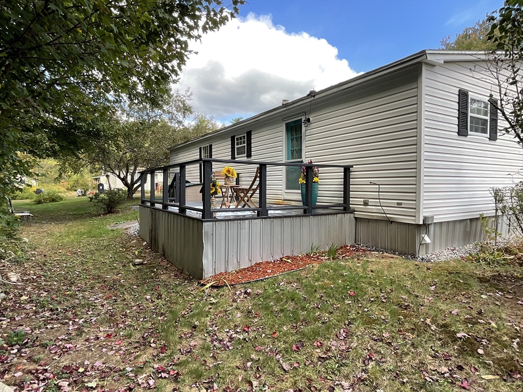 16 Agent Road Raymond, NH 03077 - Photo 9 of 35 a front view of house with yard and car parked
