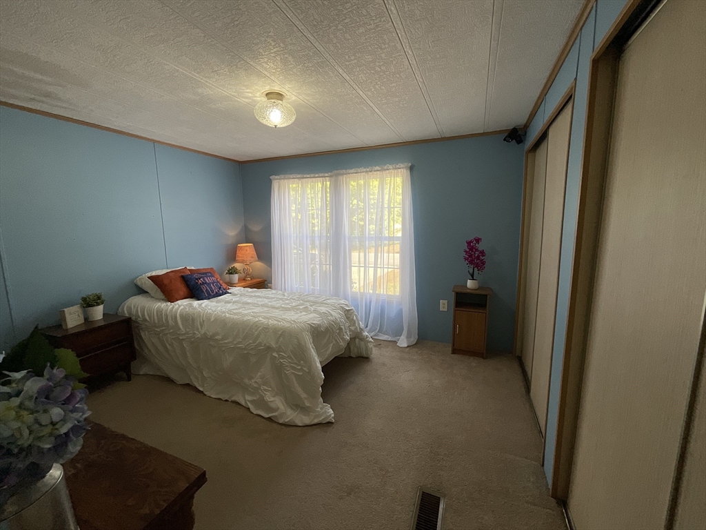 16 Agent Road Raymond, NH 03077 - Photo 10 of 35 a bedroom with a bed and a window