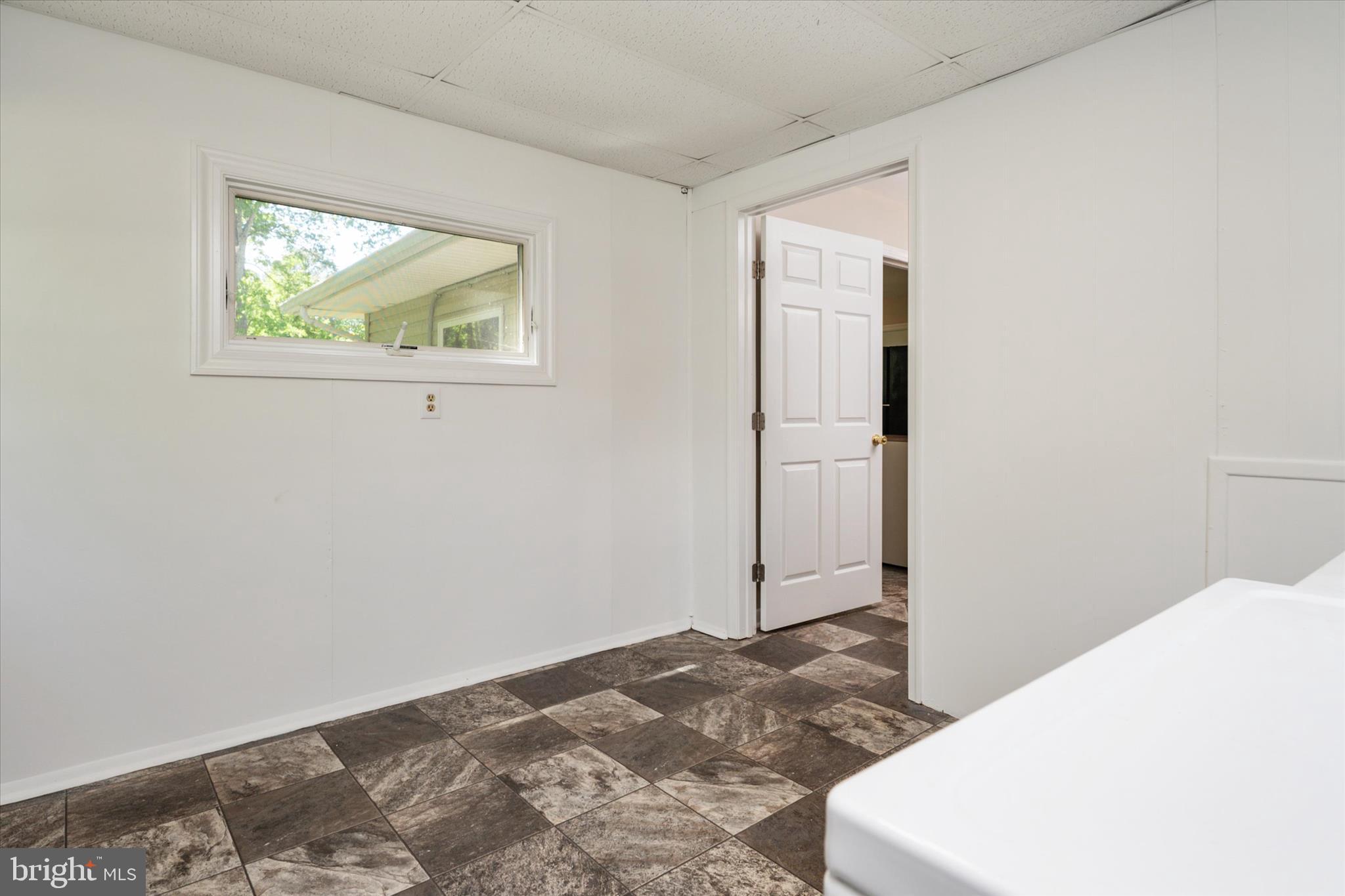 117 Rebel Road Grasonville, MD 21638 - Photo 25 of 46 Full Laundry Room in back of Home w/ Deck Access