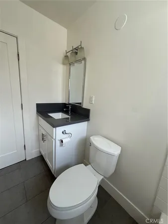 a white toilet sitting next to a bathroom sink