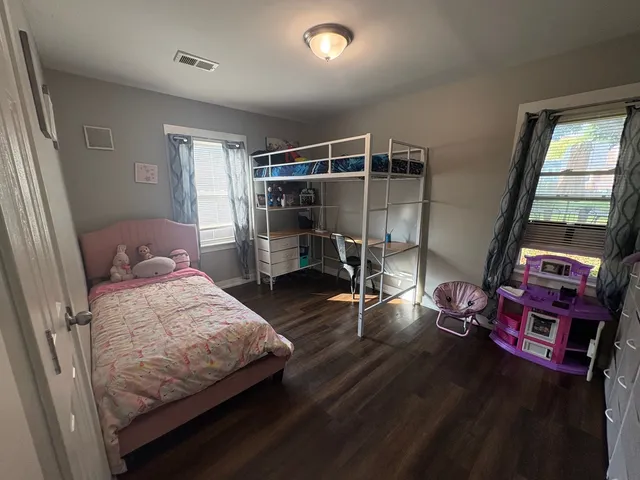 a bedroom with bed and a window