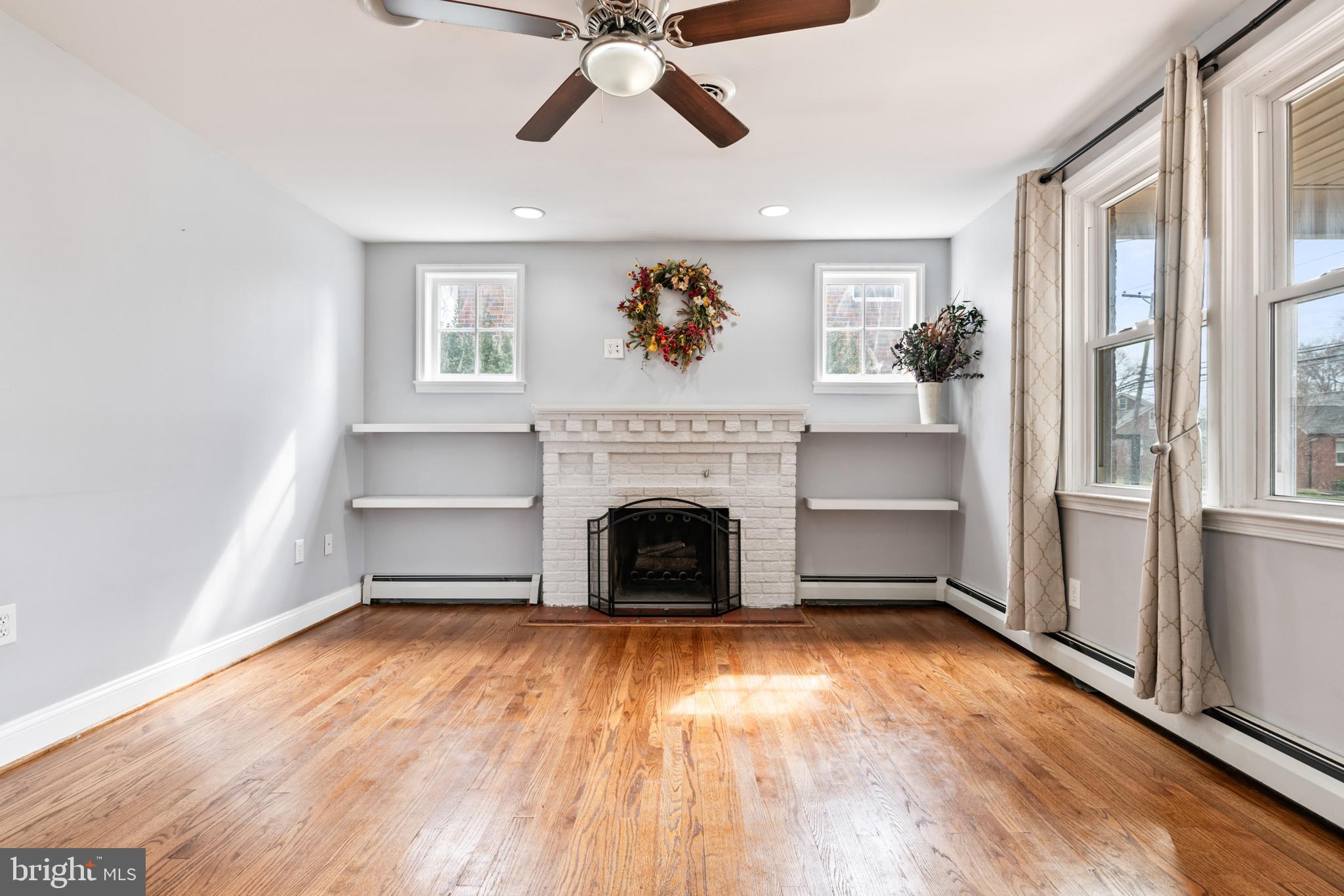 4416 Fullerton Avenue Nottingham, MD 21236 - Photo 12 of 70 a living room with a fireplace and wooden floor