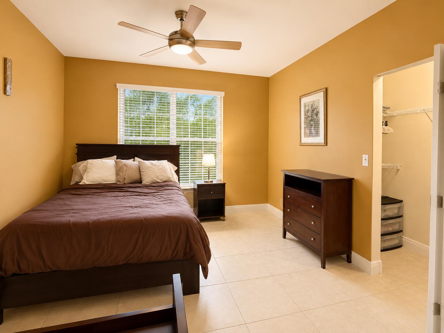 5880 West Sample Road, Unit 105 Coral Springs, FL 33067 - Photo 10 of 17 a bedroom with a bed and a dresser