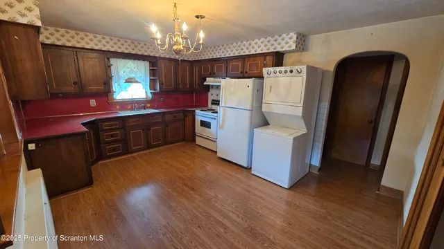 a kitchen with sink cabinets and wooden floor