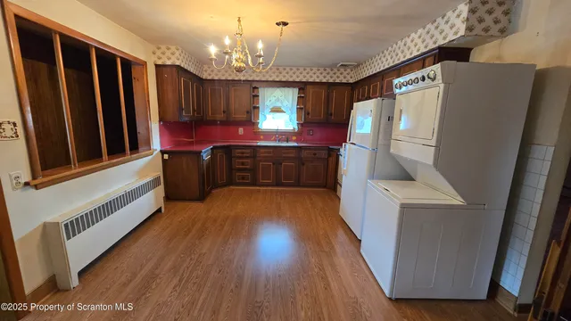 a kitchen with stainless steel appliances granite countertop a stove a sink dishwasher and a refrigerator