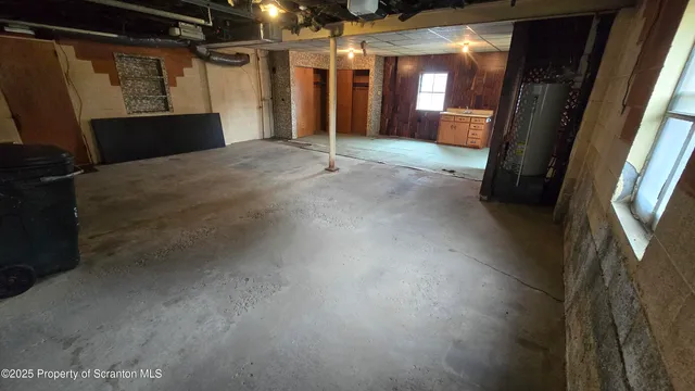 a view of an empty room with a kitchen