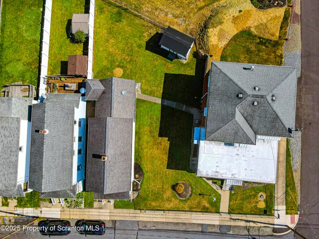 aerial view of a house with street