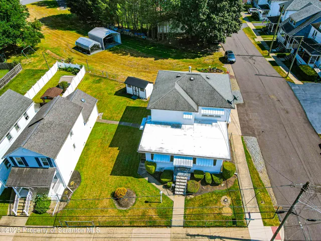 an aerial view of a house with a swimming pool