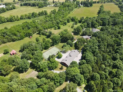 an aerial view of house with yard and outdoor seating