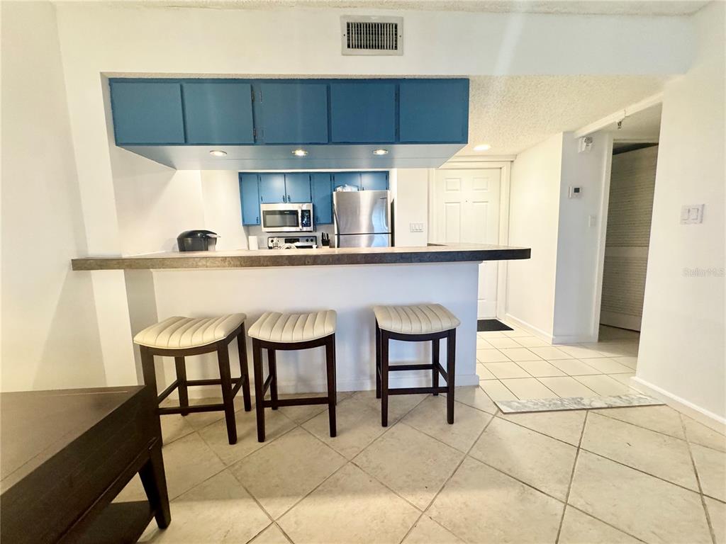 3170 Matecumbe Key Road, Unit 115 Punta Gorda, FL 33955 - Photo 11 of 43 a kitchen with a sink cabinets and window