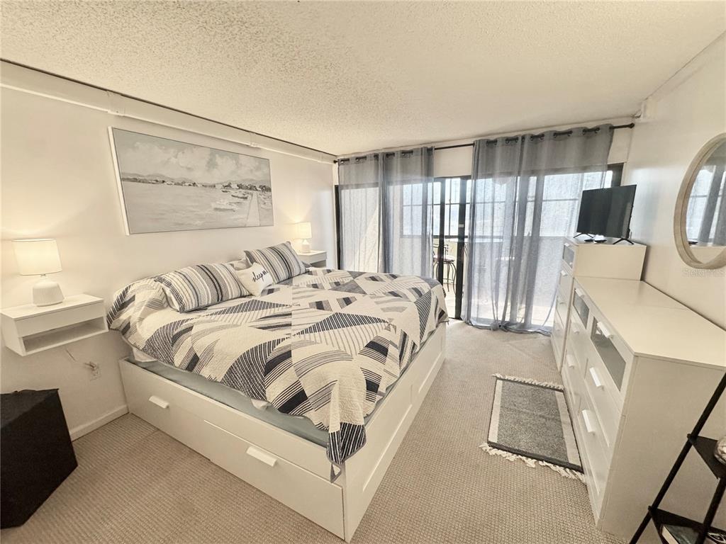 3170 Matecumbe Key Road, Unit 115 Punta Gorda, FL 33955 - Photo 13 of 43 a bedroom with a bed and wooden floor