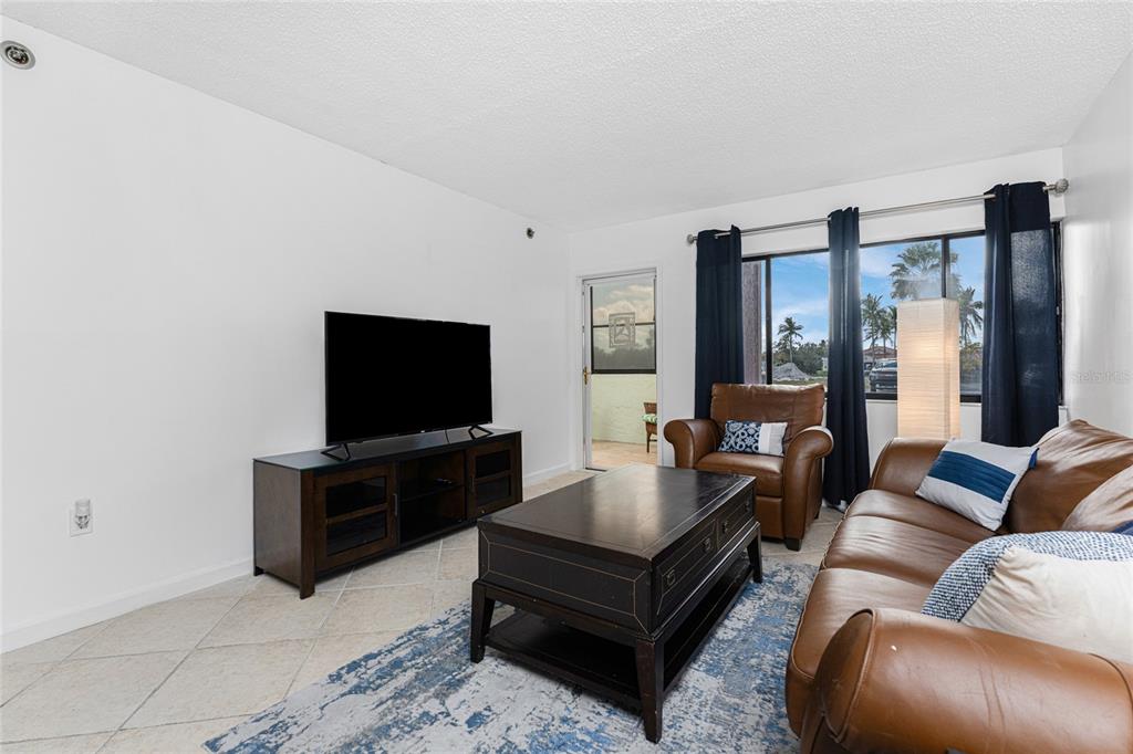 3170 Matecumbe Key Road, Unit 115 Punta Gorda, FL 33955 - Photo 14 of 59 a living room with furniture and a flat screen tv