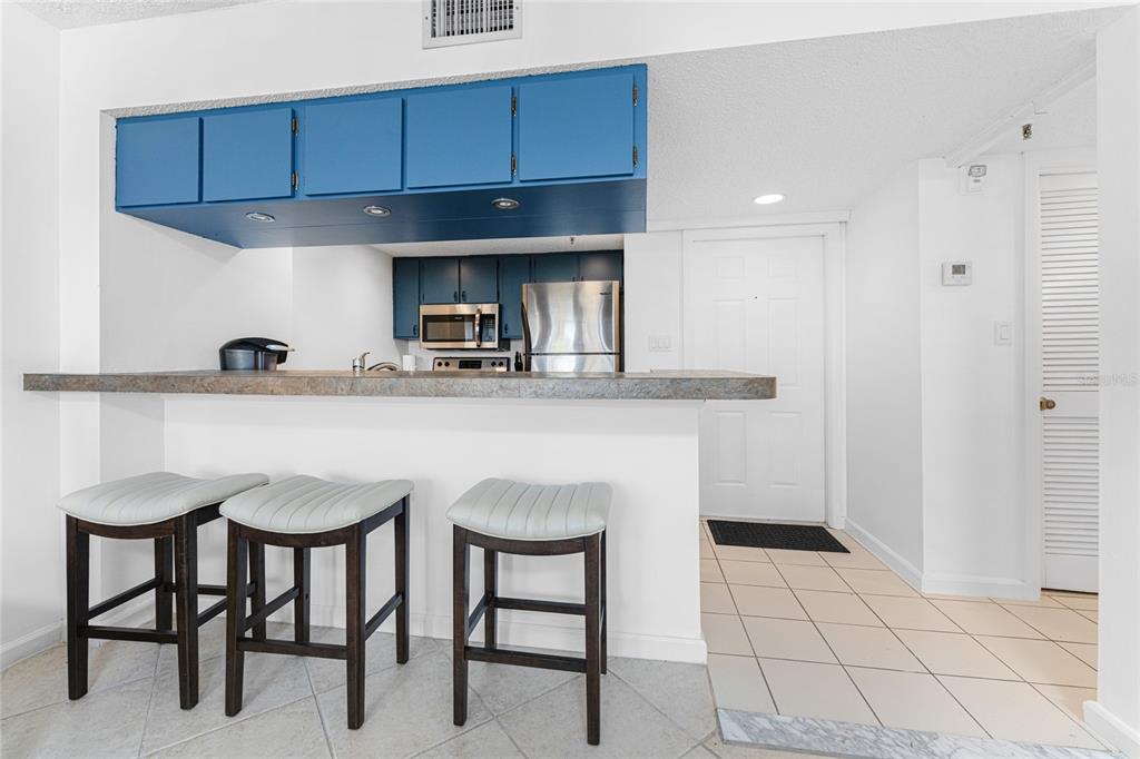 3170 Matecumbe Key Road, Unit 115 Punta Gorda, FL 33955 - Photo 15 of 59 a kitchen with granite countertop a table chairs stove and cabinets