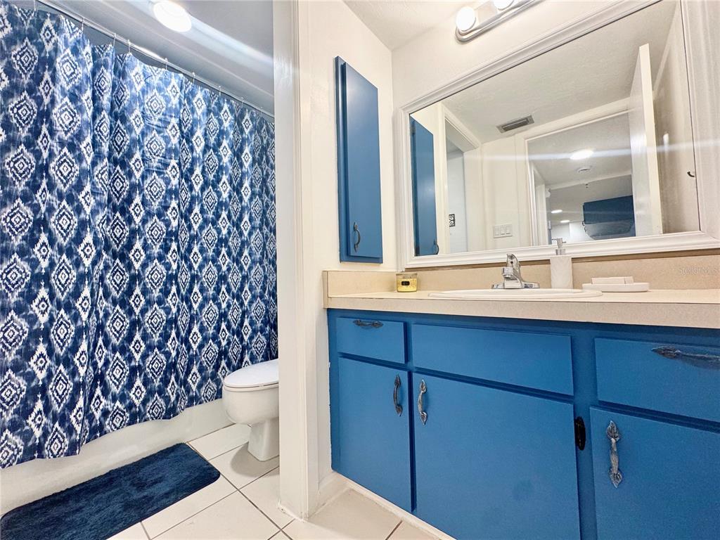 3170 Matecumbe Key Road, Unit 115 Punta Gorda, FL 33955 - Photo 17 of 43 a bathroom with a sink and a mirror