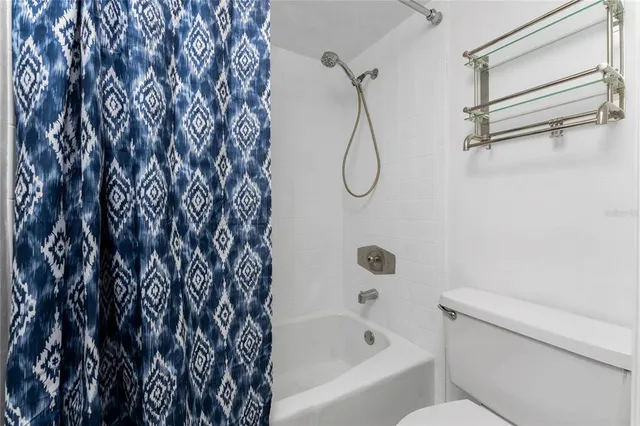 a bathroom with a shower curtain and a bathtub