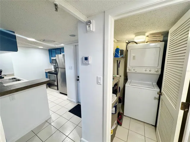 a kitchen with a sink a refrigerator and cabinets