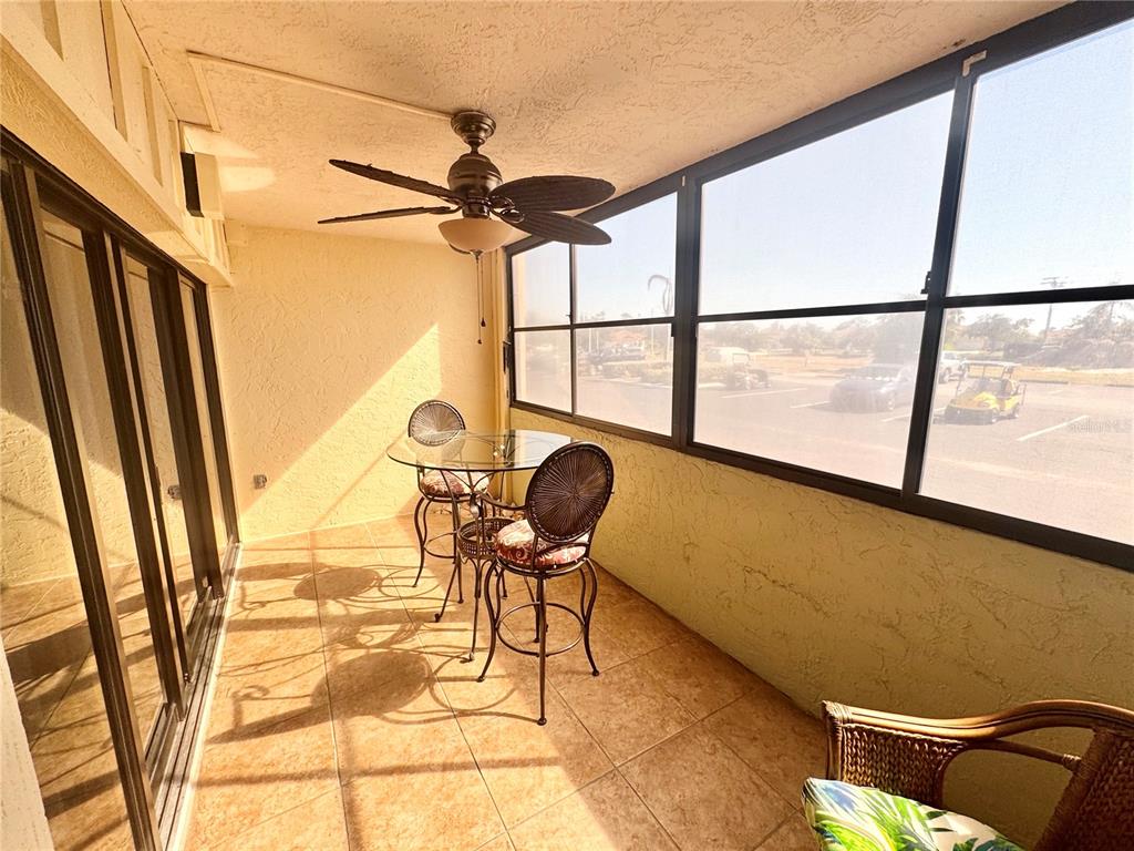 3170 Matecumbe Key Road, Unit 115 Punta Gorda, FL 33955 - Photo 22 of 43 a chair and a table in a balcony