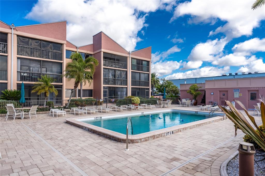 3170 Matecumbe Key Road, Unit 115 Punta Gorda, FL 33955 - Photo 26 of 59 a view of a house with swimming pool and sitting area